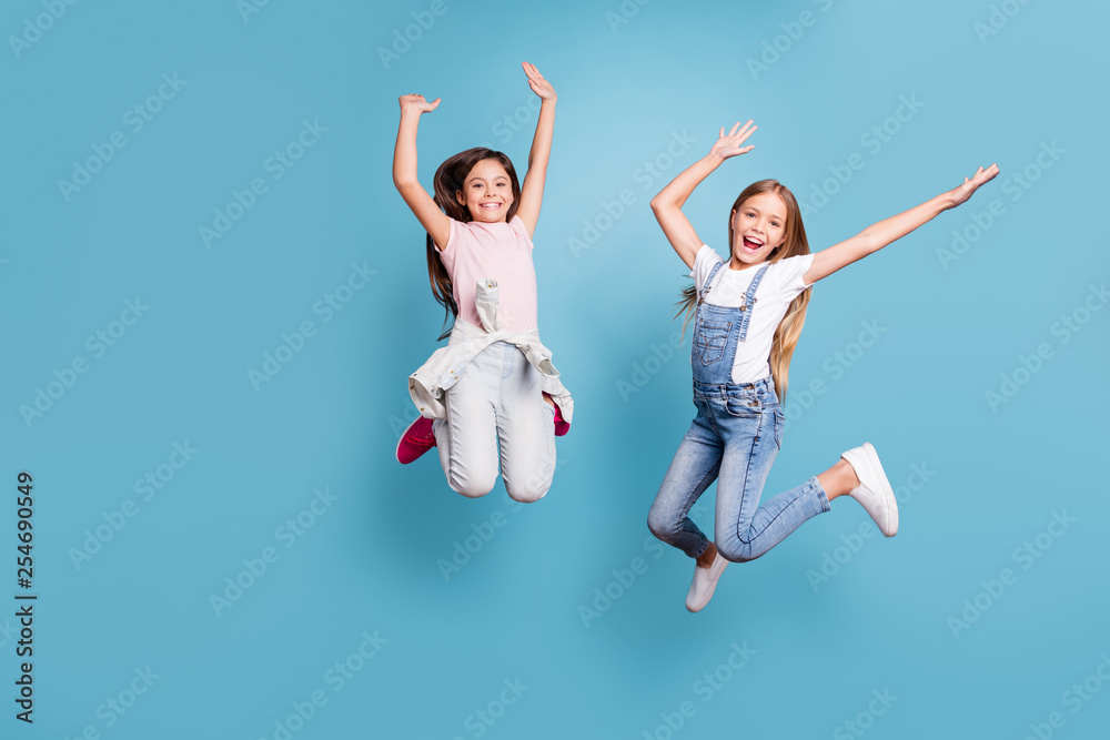 Full length body size view of two people nice lovely attractive charming cheerful careless glad straight-haired pre-teen girls having fun party overjoy cool day isolated on blue pastel background Full length body size view of two people nice lovely attractive charming cheerful careless glad straight-haired pre-teen girls having fun party overjoy cool day isolated on blue pastel background