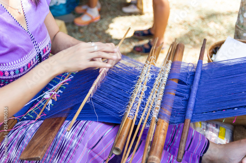 Thai Old women are using the machine - Household Loom weaving is Household occupation - for homemade silk or textile production of Thailand 