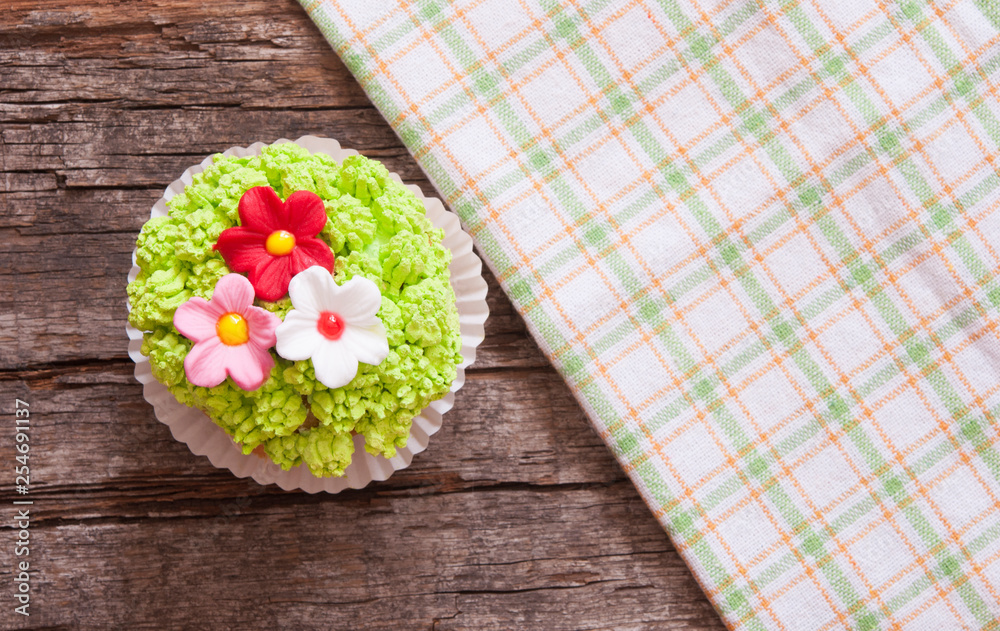 Cupcakes decorated with flowers for springtime wooden background Cupcakes decorated with flowers for springtime wooden background