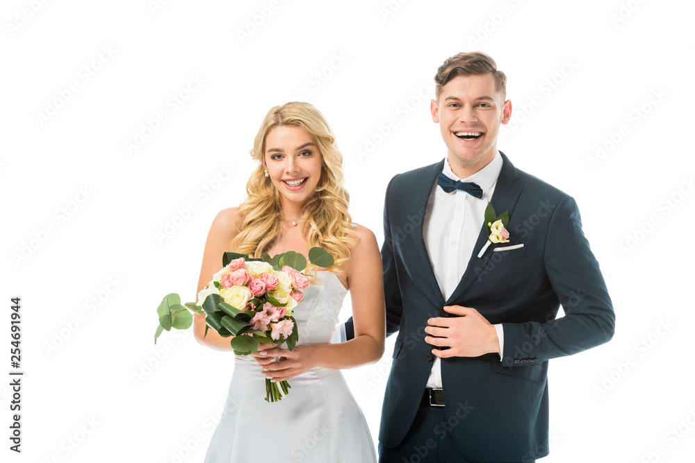 smiling bride with beautiful wedding bouquet, and groom in elegant black suit isolated on white smiling bride with beautiful wedding bouquet, and groom in elegant black suit isolated on white