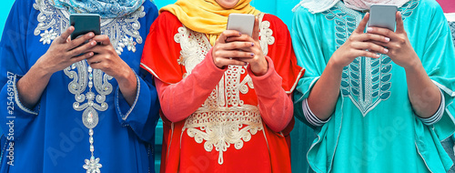 Photography Young Muslim people using their mobile smart phones in the college - Arabian gir