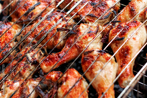 Grilled chicken steak on barbecue grill.