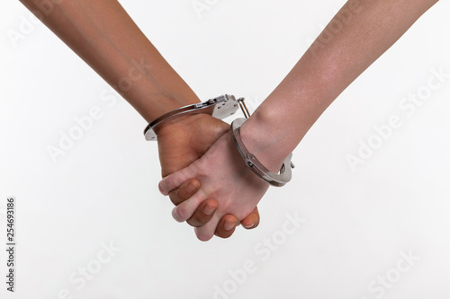Desperate little kids covered in metal handcuffs binding fingers