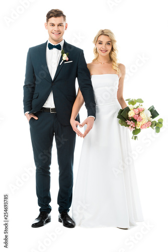 Photo beautiful bride and handsome groom showing heart sign with hands isolated on whi