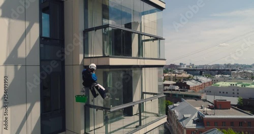 Industrial climber - Facade Cleaning. Aerial photography air drone