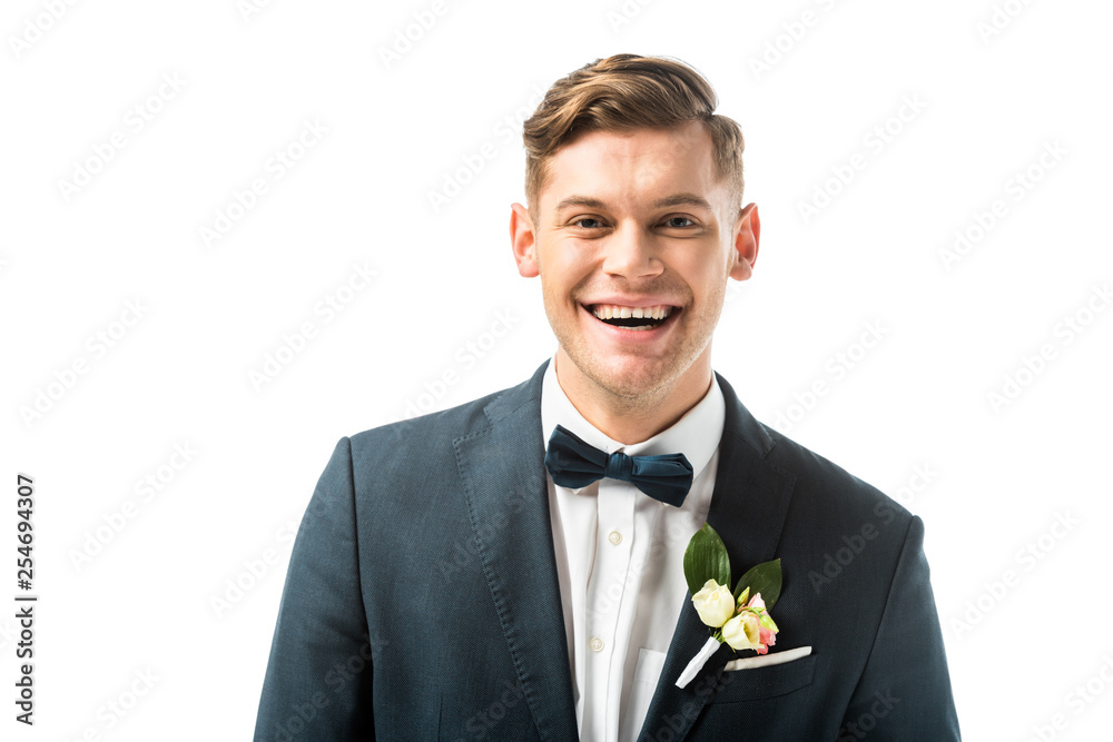happy handsome bridegroom in bowtie and jacket with boutonniere looking at camera isolated on white happy handsome bridegroom in bowtie and jacket with boutonniere looking at camera isolated on white