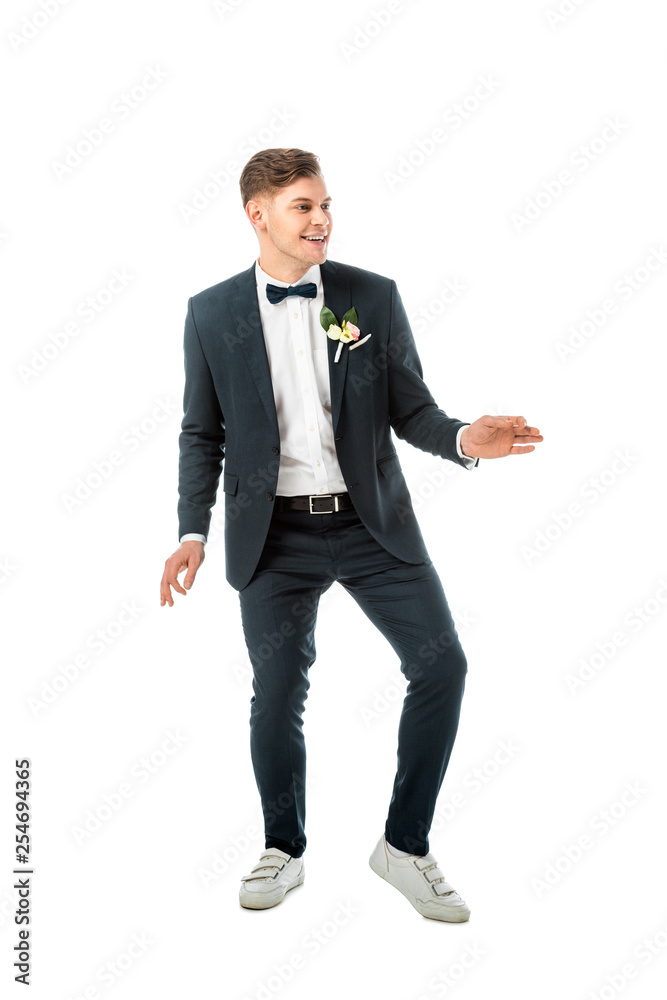 cheerful groom dancing in black elegant suit and white sneakers isolated on white cheerful groom dancing in black elegant suit and white sneakers isolated on white