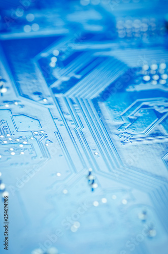 Printed circuit Board with microchips and conductors close-up, soft focus, vertically
