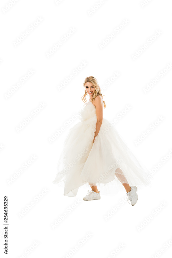 beautiful groom in wedding dress and sneakers dancing while looking at camera isolated on white beautiful groom in wedding dress and sneakers dancing while looking at camera isolated on white