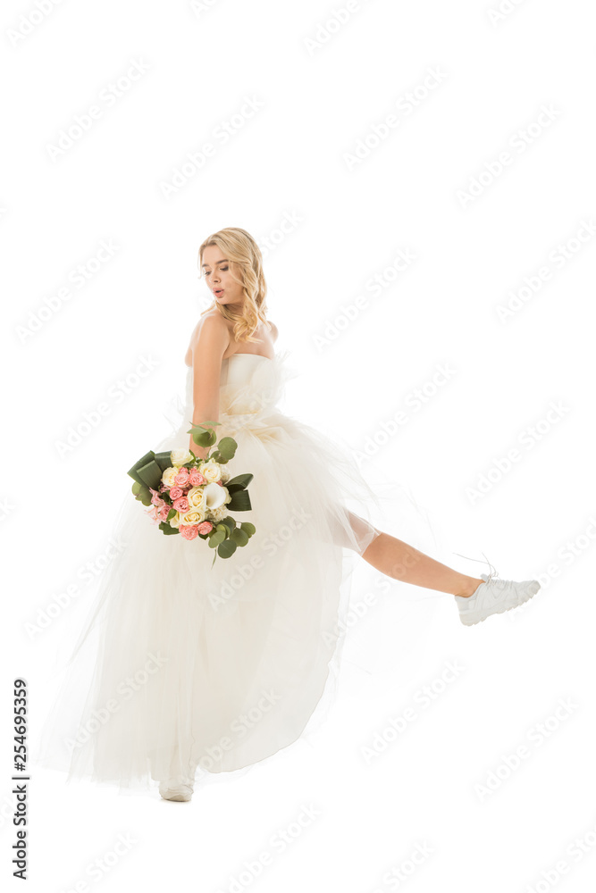 pretty happy bride posing in wedding dress and sneakers isolated on white