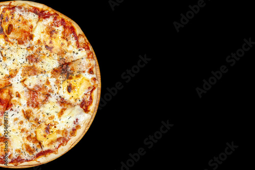 Fresh pizza with meat beaf chicken pork, tomatoes, vegetables, ushrooms on dark black background closeup photo