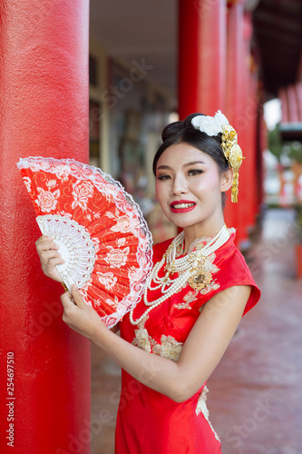 Asian woman with hinese traditional dress cheongsam holding chinese paper fan. photo