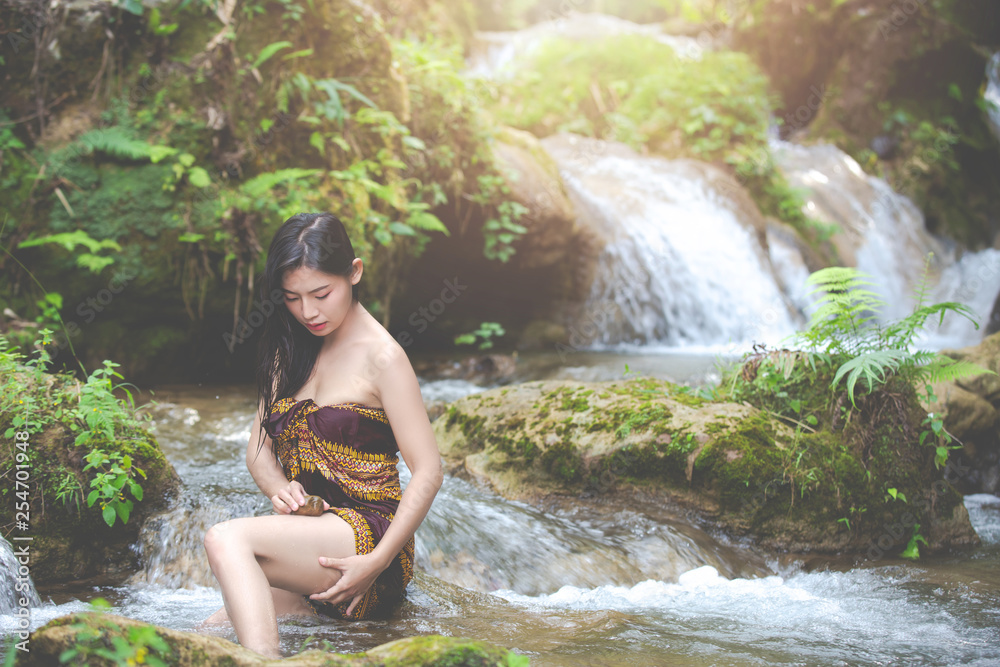 Happy bathing women at the natural waterfall. Happy bathing women at the natural waterfall.
