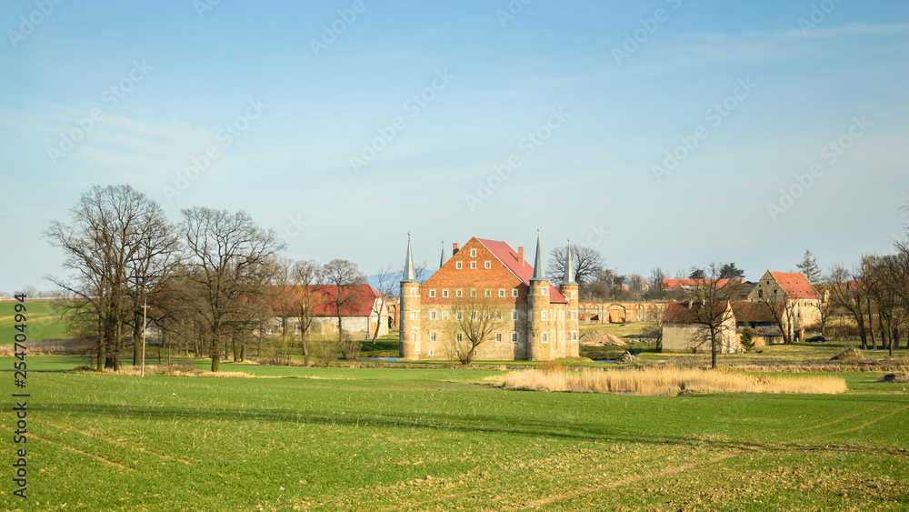 Folwark, a small castle with a moat and a pond.