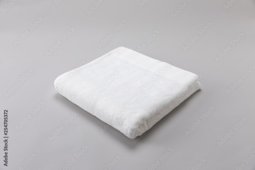 White single towel folded on gray background White single towel folded on gray background