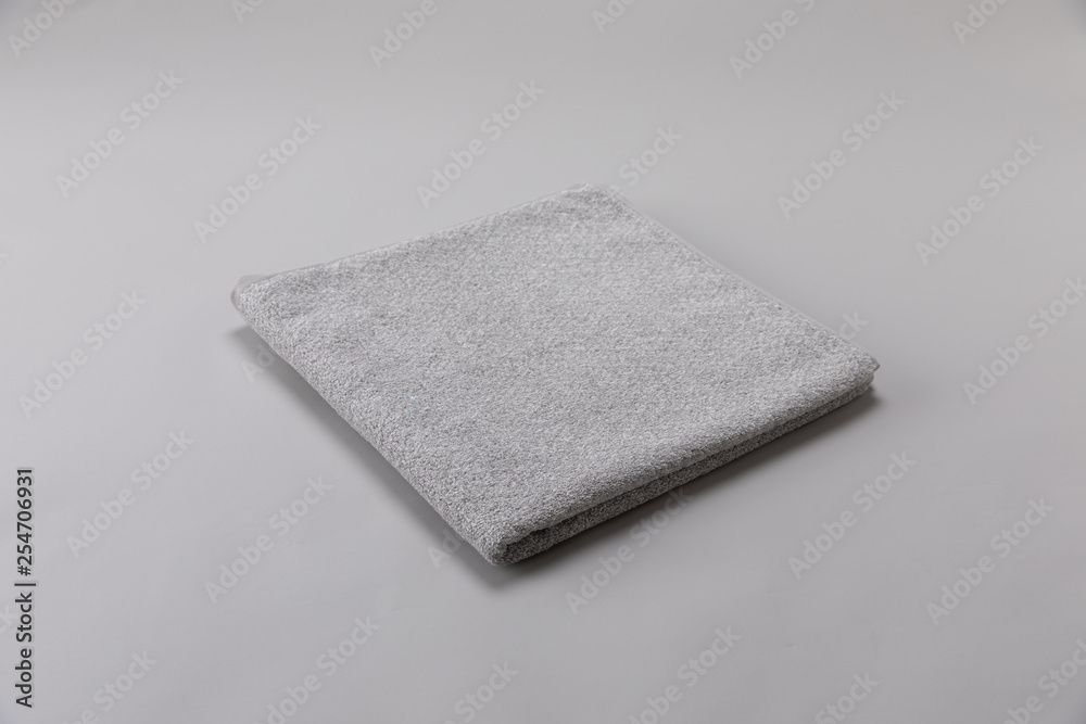gray single towel folded on gray background