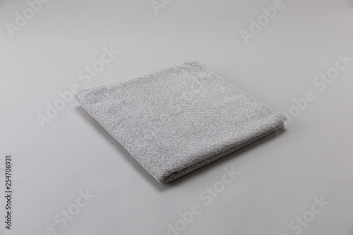 gray single towel folded on gray background