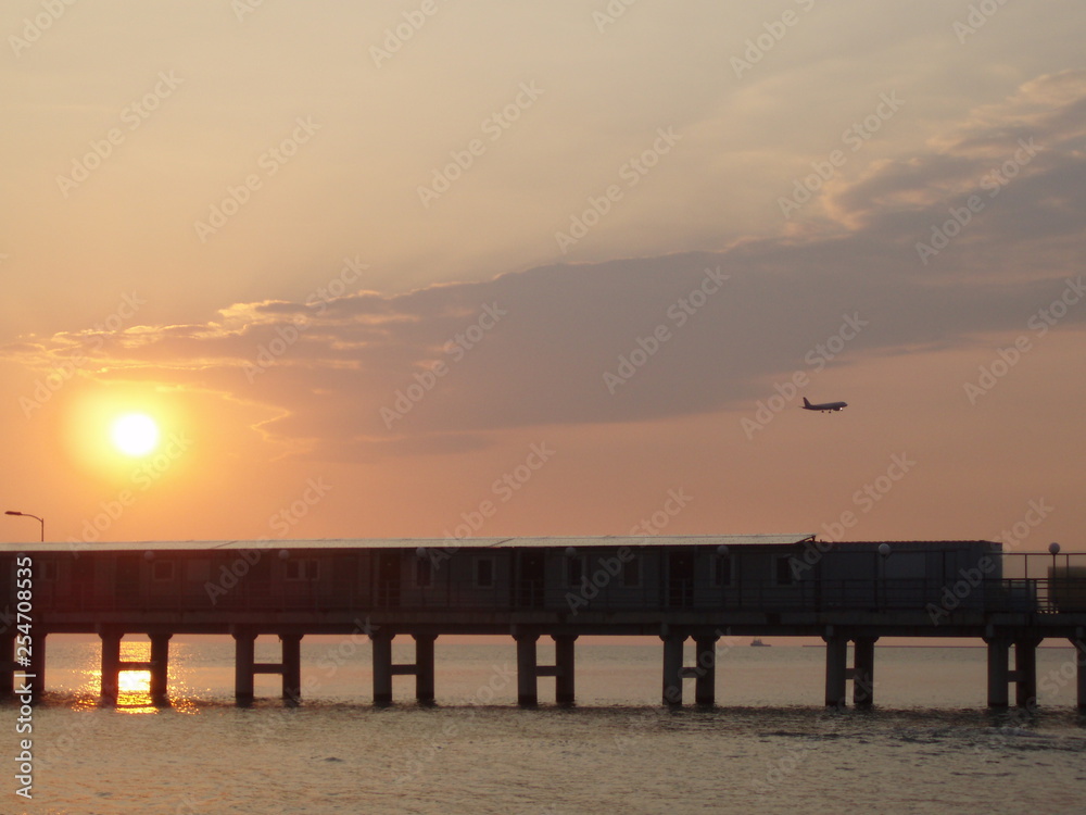 sunset on the beach the plane flies over the sea aircraft, plane, airplane, jet, aeroplane