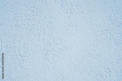 roughcast plaster wall background texture in light blue