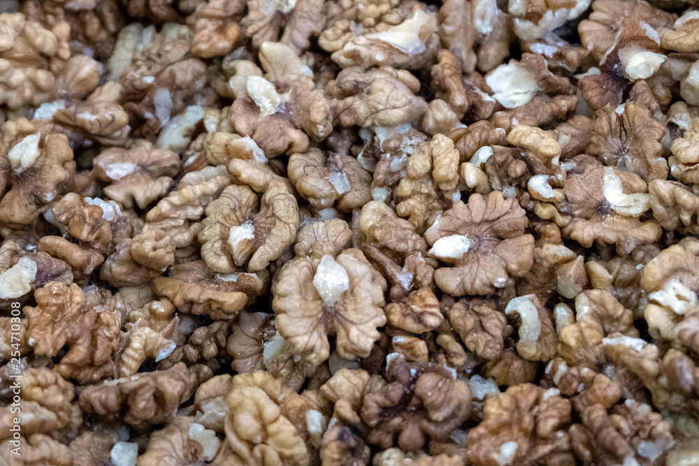 Lots of shelled walnuts. Food background. Close-up. Selective focus. Lots of shelled walnuts. Food background. Close-up. Selective focus.