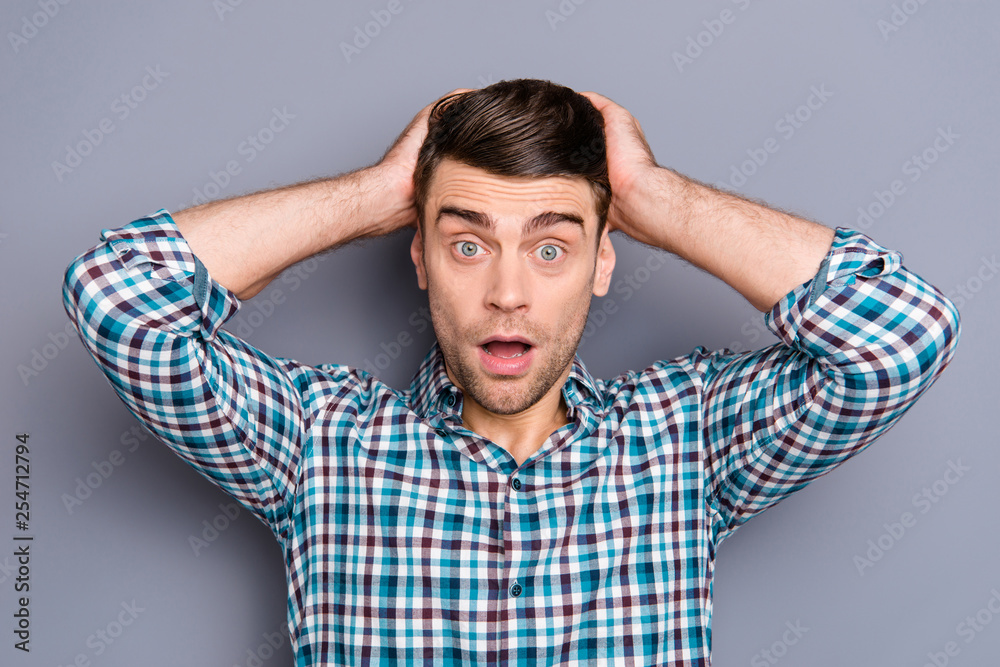 Close up photo amazing he him his man arms on head ideal perfect hairstyle styling mouth widely open eyes full fear oh no expression wearing casual plaid checkered outfit isolated grey background Close up photo amazing he him his man arms on head ideal perfect hairstyle styling mouth widely open eyes full fear oh no expression wearing casual plaid checkered outfit isolated grey background