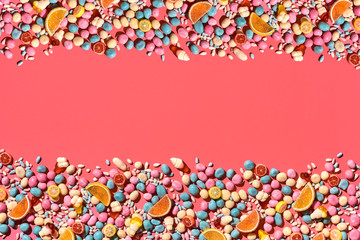 Various sweets, sweets are palced on the photo on the coral background