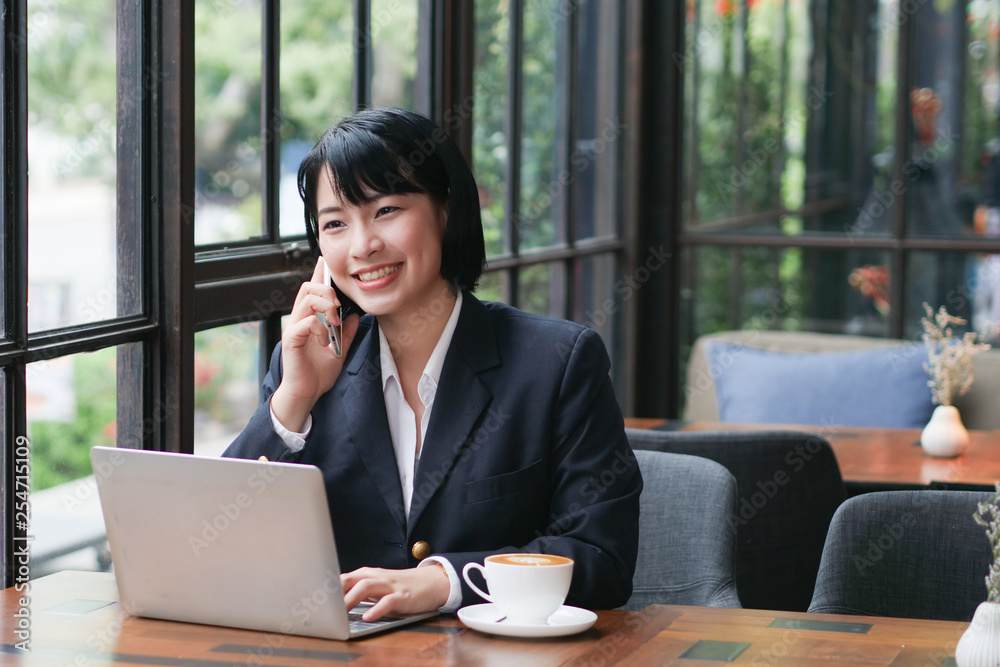 Asian business girl working and drinking coffee in cafe Asian business girl working and drinking coffee in cafe