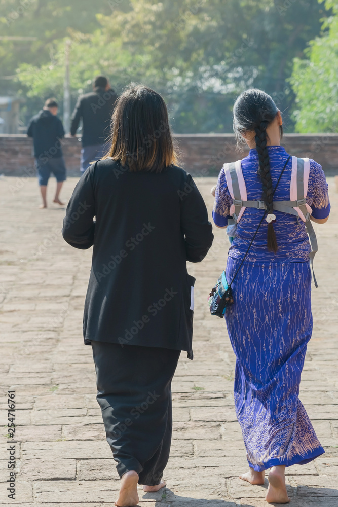 Backview of female tourists at ancient Pa Hto Taw Gyi Pagoda ruins at Mingun city near Mandalay, Myanmar. Backview of female tourists at ancient Pa Hto Taw Gyi Pagoda ruins at Mingun city near Mandalay, Myanmar.