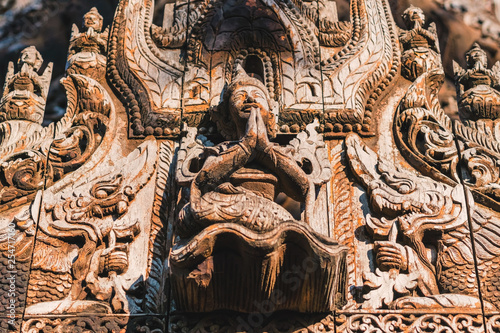 Archaeological, Close Up of carved art figures on old wood carvings on the wall temple at Shwe Nan Daw Kyaung (Golden Palace Monastery) in Mandalay, Myanmar