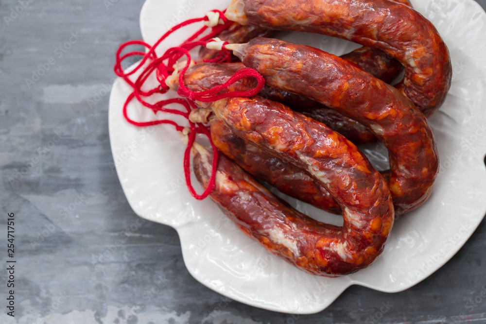 Fototapeta premium typical portuguese smoked sausages on beautiful white dish
