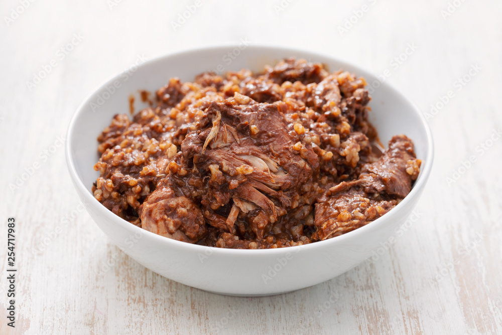 rabbit with rice and sauce on white bowl rabbit with rice and sauce on white bowl