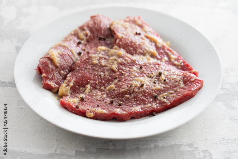 raw meat with spices on white dish raw meat with spices on white dish