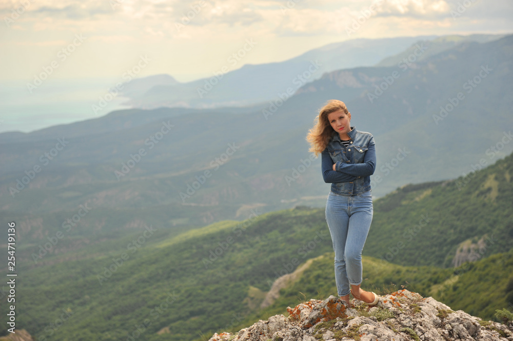 young woman on top of the mountain