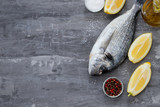 raw fish with olive oil and lemon background