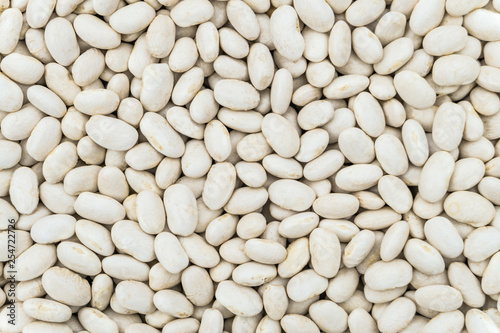 Dried white seeds of beans background. Food groceries product close-up.
