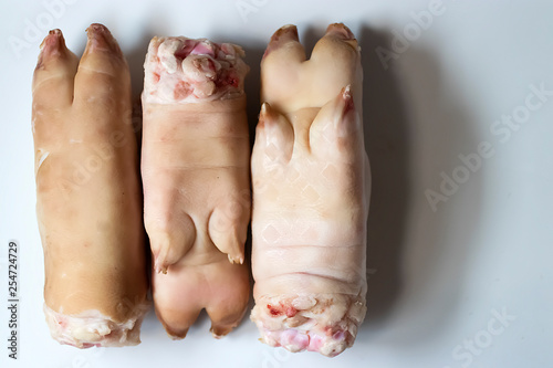 Legs of a pig with hooves on a white background.