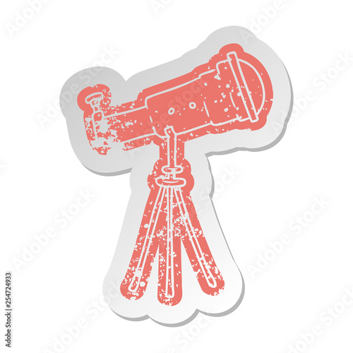 distressed old sticker of a large telescope