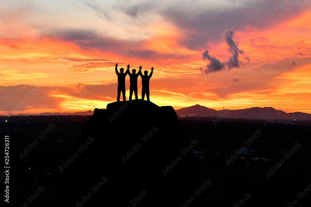 Fototapeta premium silhouette three men on peak mountain