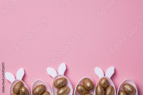 Photography Gold glitter eggs in a white easter bunny egg shape with ears