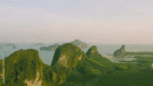 a long and high shaped island with mangroves on the back of the island .infront of Baan Hinrom fishing village in Phang Nga Thailand photo