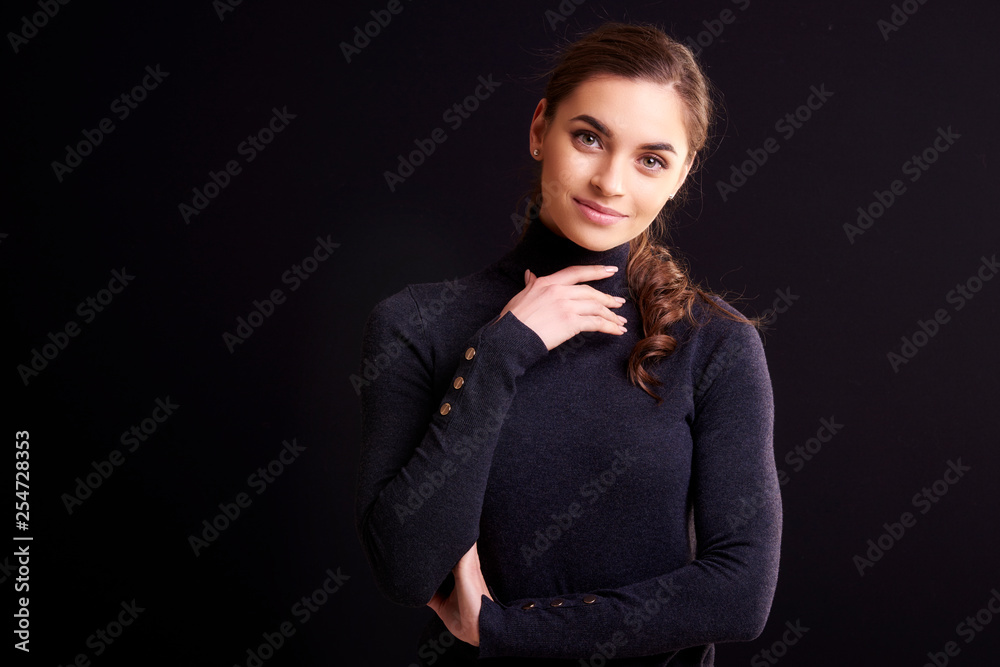 Beautiful smiling woman posing at isolated black background Beautiful smiling woman posing at isolated black background