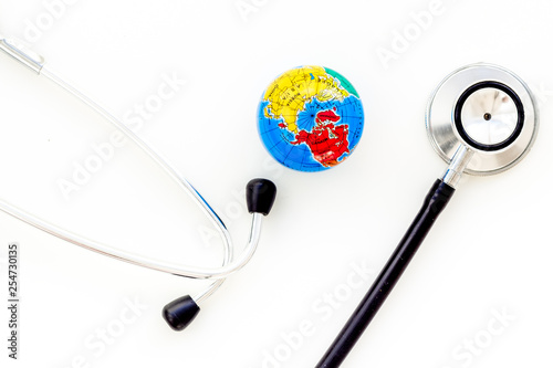 SOS Save the planet and ecology concept with the earth and phonendoscope on white background top view