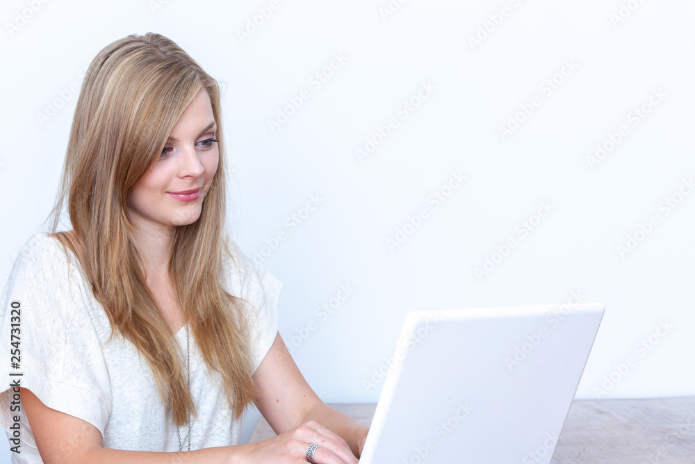 Young woman using a notebook computer indoors Young woman using a notebook computer indoors