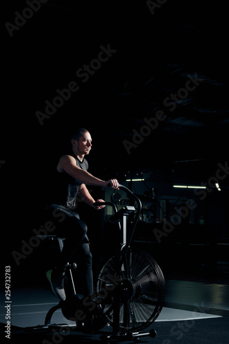 Male using air bike for cardio workout at cross training gym.