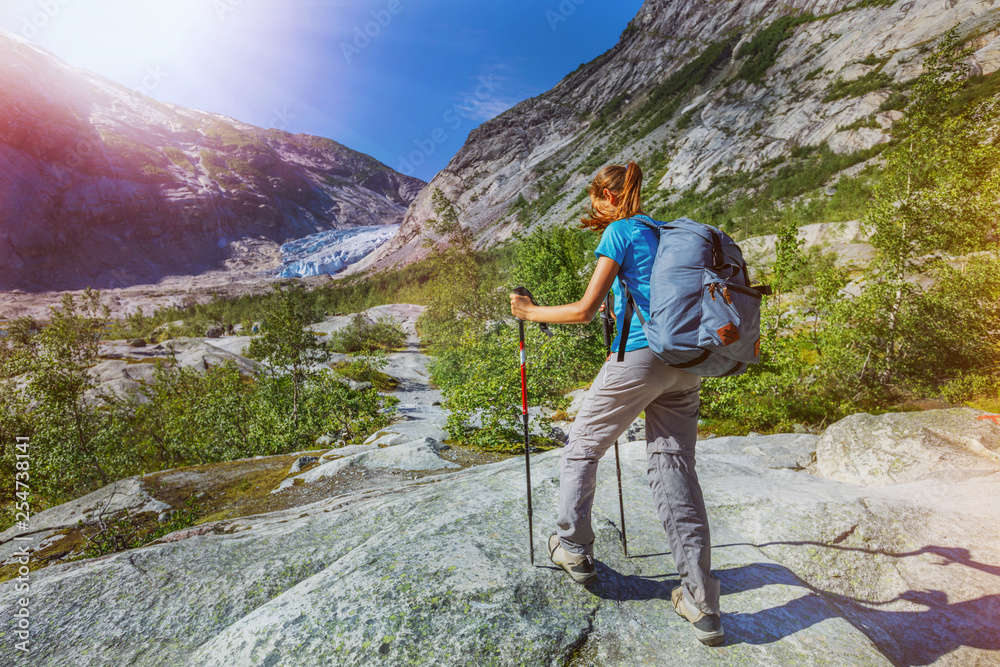 Best Norway hike. Cute girl with hiking equipment in the mountains Stock  Photo