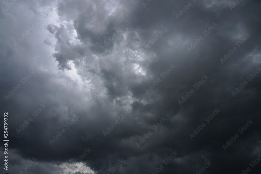 Dark, grim, stormy, rainy sky with rays of light. Scary hurricane clouds. Natural element. Stock Photo for your design Dark, grim, stormy, rainy sky with rays of light. Scary hurricane clouds. Natural element. Stock Photo for your design