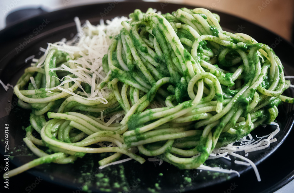 Spaghetti with green arugula sauce of garlic and olive oil, with grated cheese. Spaghetti with green arugula sauce of garlic and olive oil, with grated cheese.