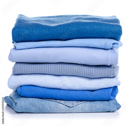 Stack blue clothes and jeans on white background isolation