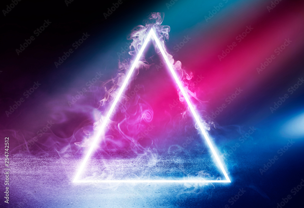 Neon triangle shape in smoke on a dark background. Background of empty room with concrete floor, neon light Neon triangle shape in smoke on a dark background. Background of empty room with concrete floor, neon light