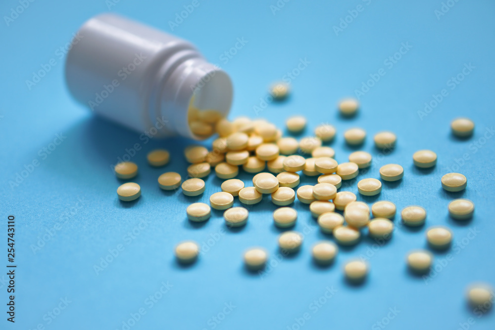 Assorted pharmaceutical medicine pills, tablets and capsules and bottle on blue background. Drugs and various narcotic substances. Copy space for text. Stock photo for design Assorted pharmaceutical medicine pills, tablets and capsules and bottle on blue background. Drugs and various narcotic substances. Copy space for text. Stock photo for design